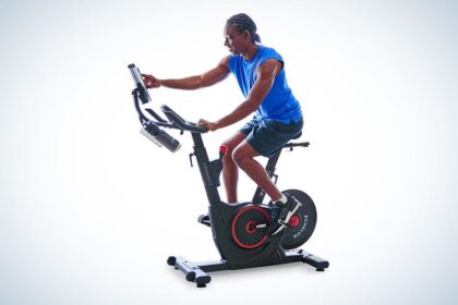 A person on a workout bike in a pattern on a plain background