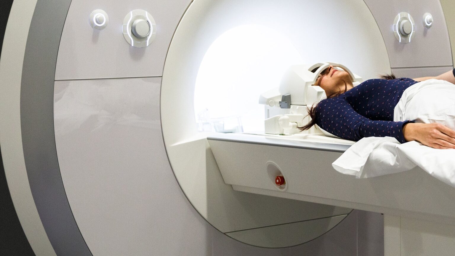 A woman laying down in an fMRI machine. Patients in the study were examined using an fMRI machine such as this one. fMRI is a noninvasive way to measure and map activity in the brain.
