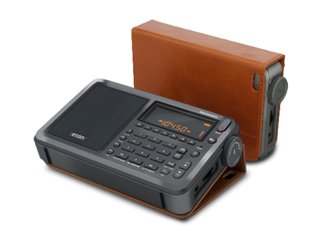 A portable radio with a leather case on a plain background.
