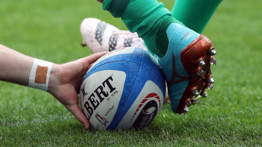 Rugby Ball being kicked by player
