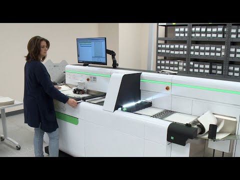 Archivist scanning documents at National Archives