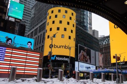 Monitors display Bumble Inc. signage during the company's initial public offering (IPO) in front of the Nasdaq MarketSite in New York, U.S., on Thursday, Feb. 11, 2021.